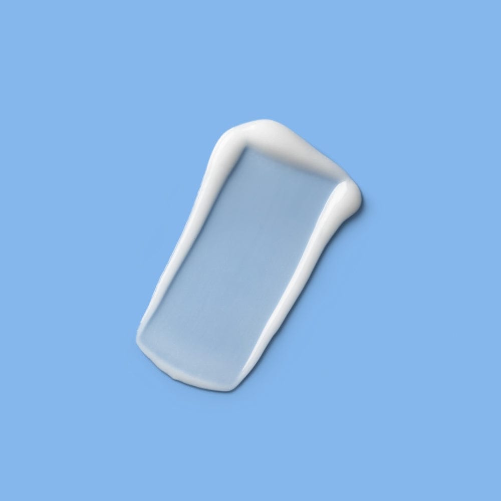 A narrow, rectangular streak of semi-transparent white cream or gel on a blue background, representing lightweight product texture.