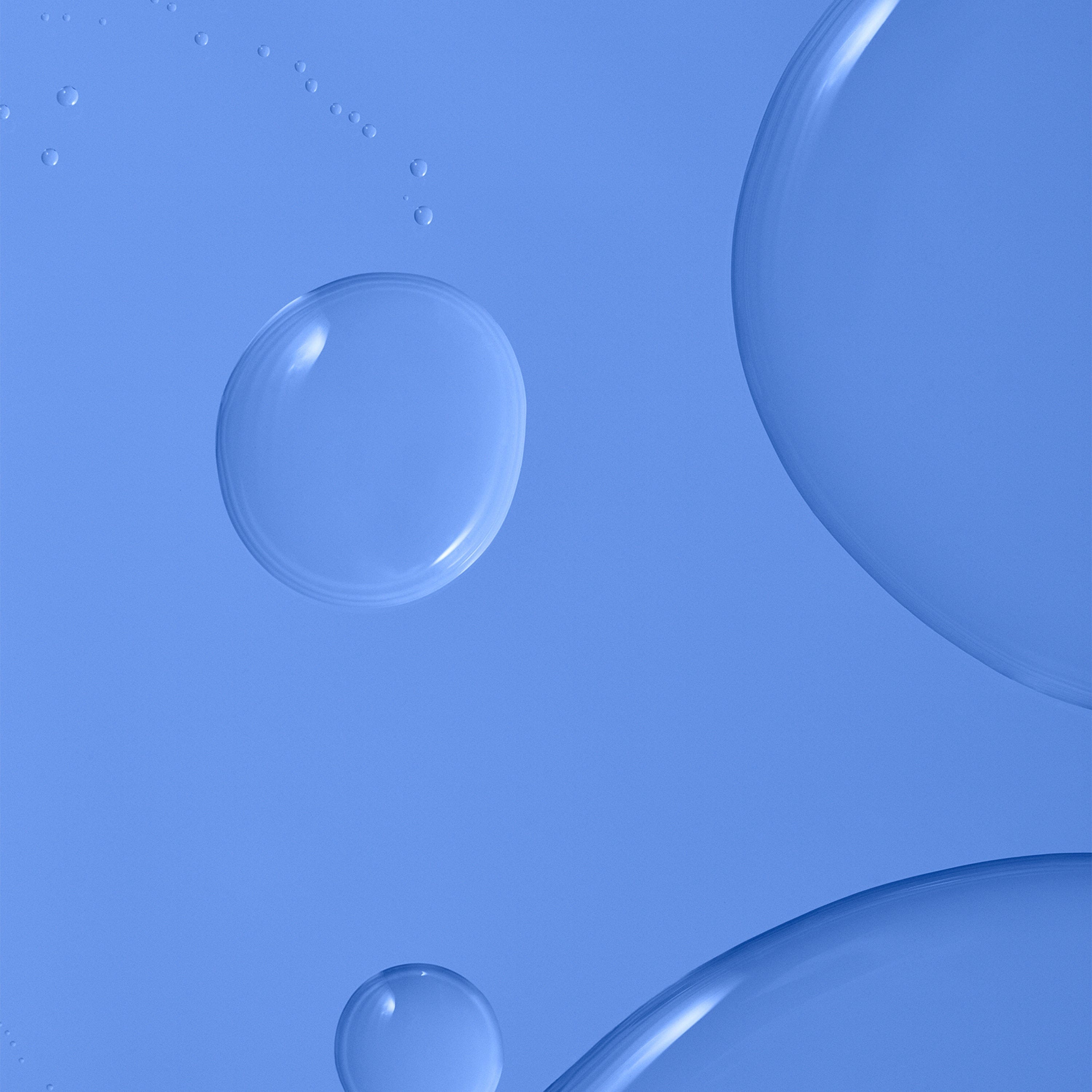 Transparent liquid over a blue background.