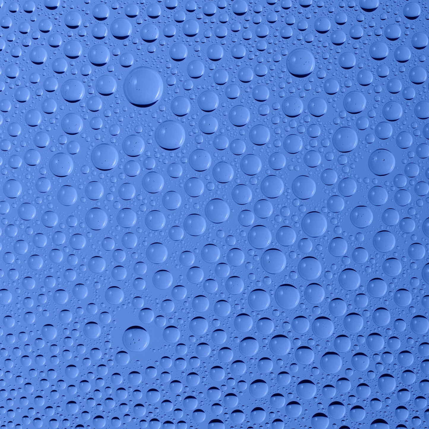 A closeup of blue background with water droplets on it.