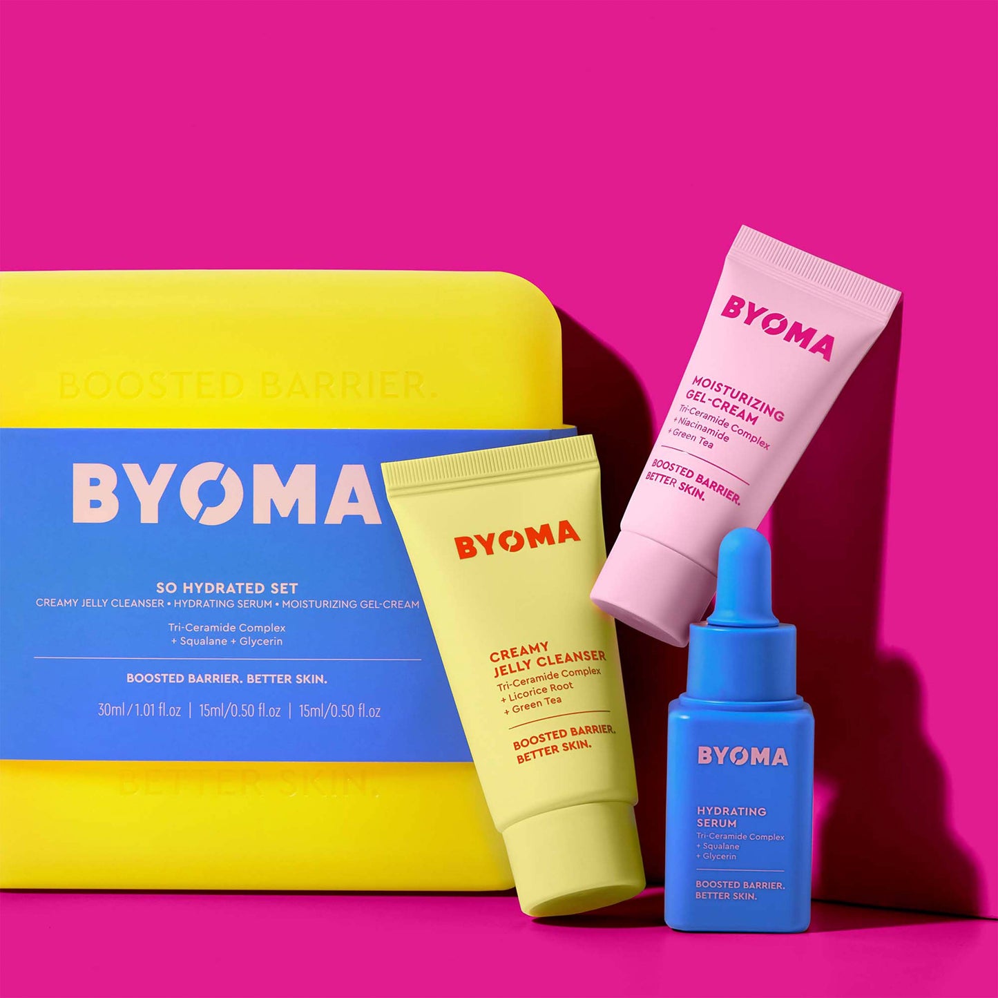 BYOMA SO HYDRATED SET kit with CREAMY JELLY CLEANSER, MOISTURIZING GEL-CREAM and HYDRATING SERUM against a pink background.