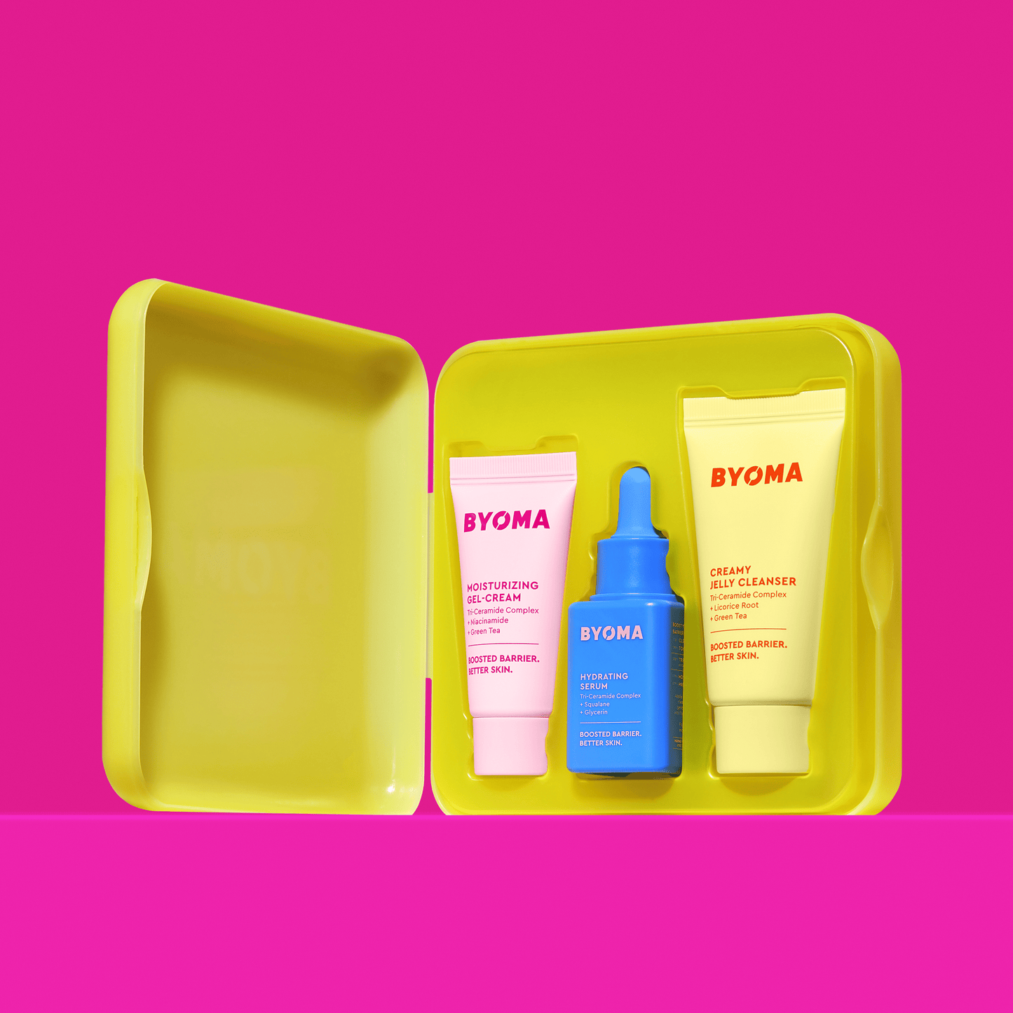 An open kit of BYOMA SO HYDRATED SET with MOISTURIZING GEL-CREAM, HYDRATING SERUM and CREAMY JELLY CLEANSER against a pink background.