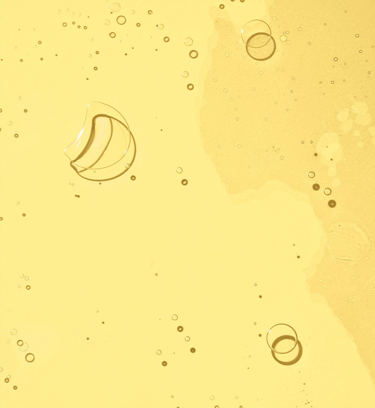 Yellow background with transparent liquid and bubbles.