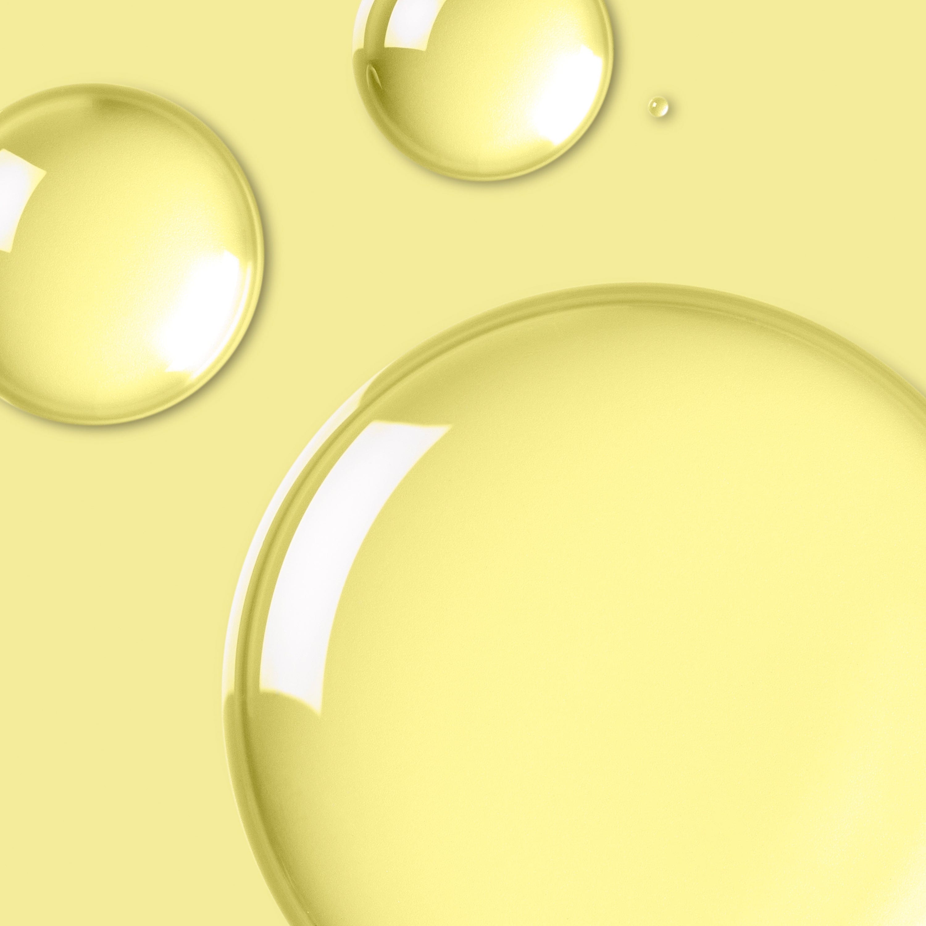 Transparent liquid on a yellow background.