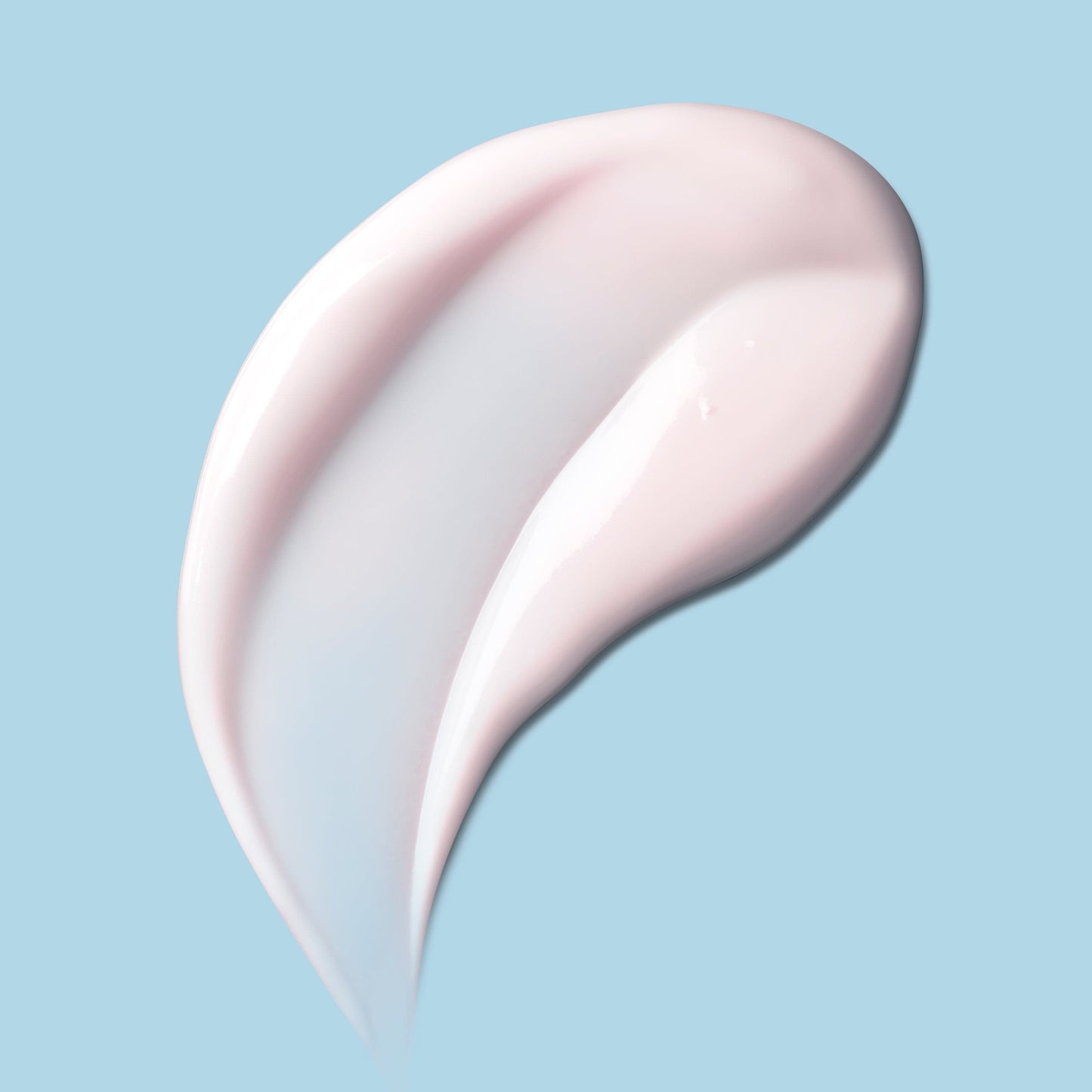A swab of thick white cream against a blue background.
