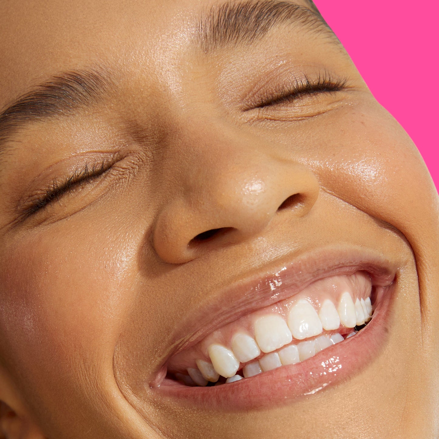 Closeup of a smiling girl with eyes closed.