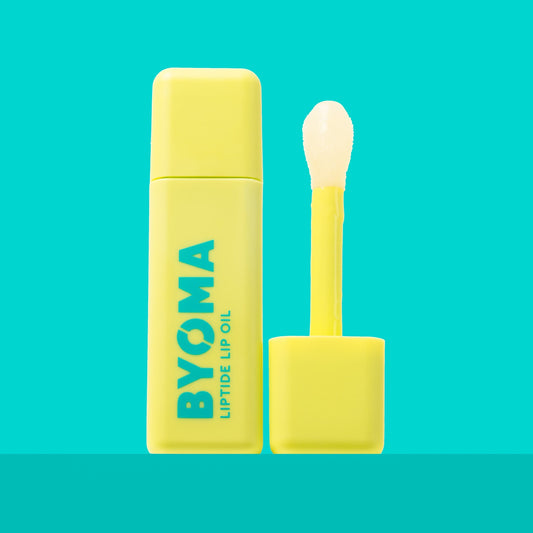 BYOMA LIPTIDE LIP OIL and its dispenser against an aqua blue background.