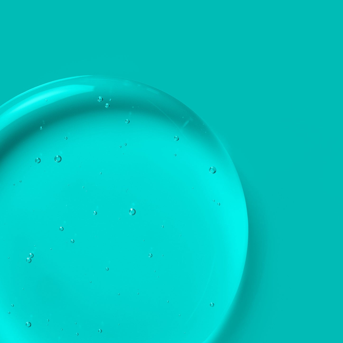 Transparent liquid with bubbles against a blue background.