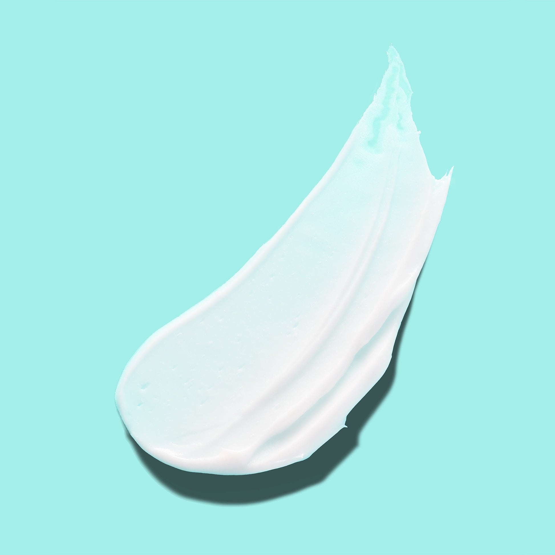 A thick white cream against a blue background.