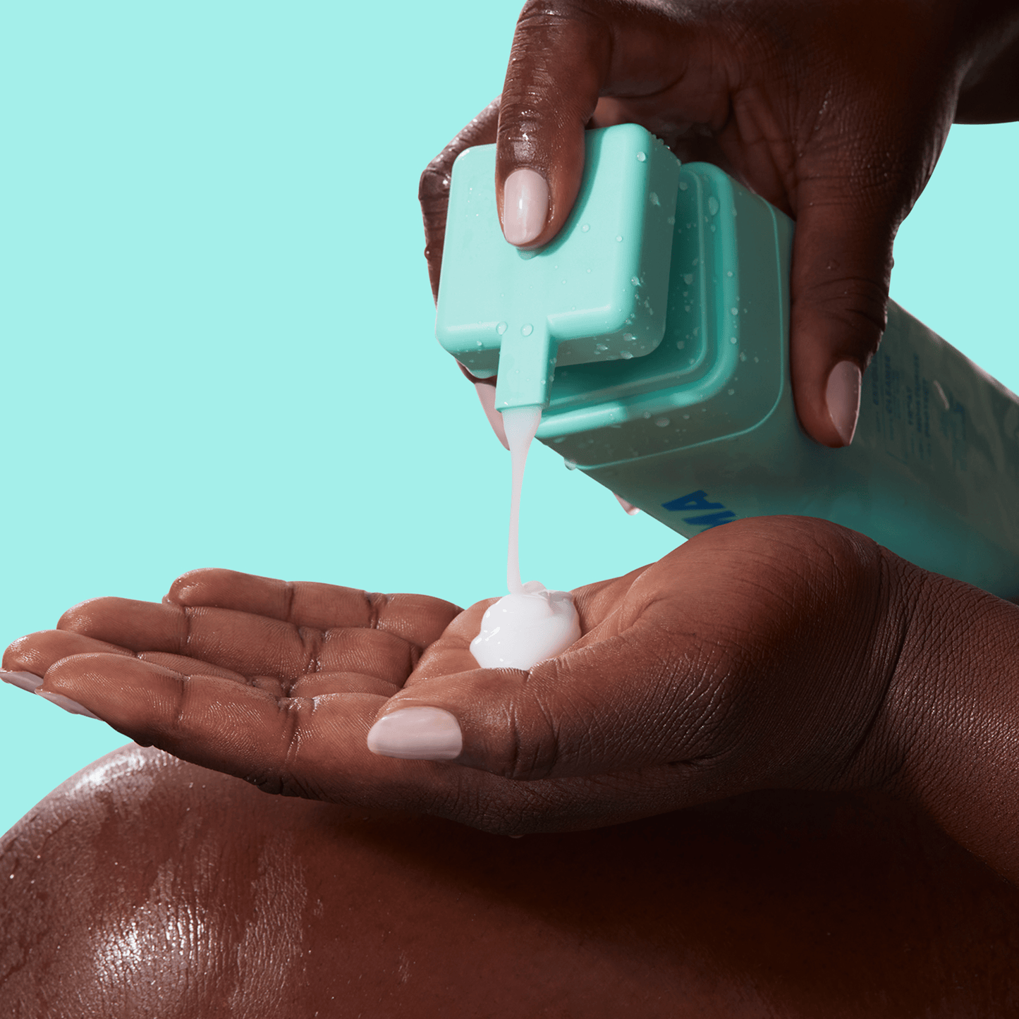 A black hand squeezing BYOMA product onto the other hand.