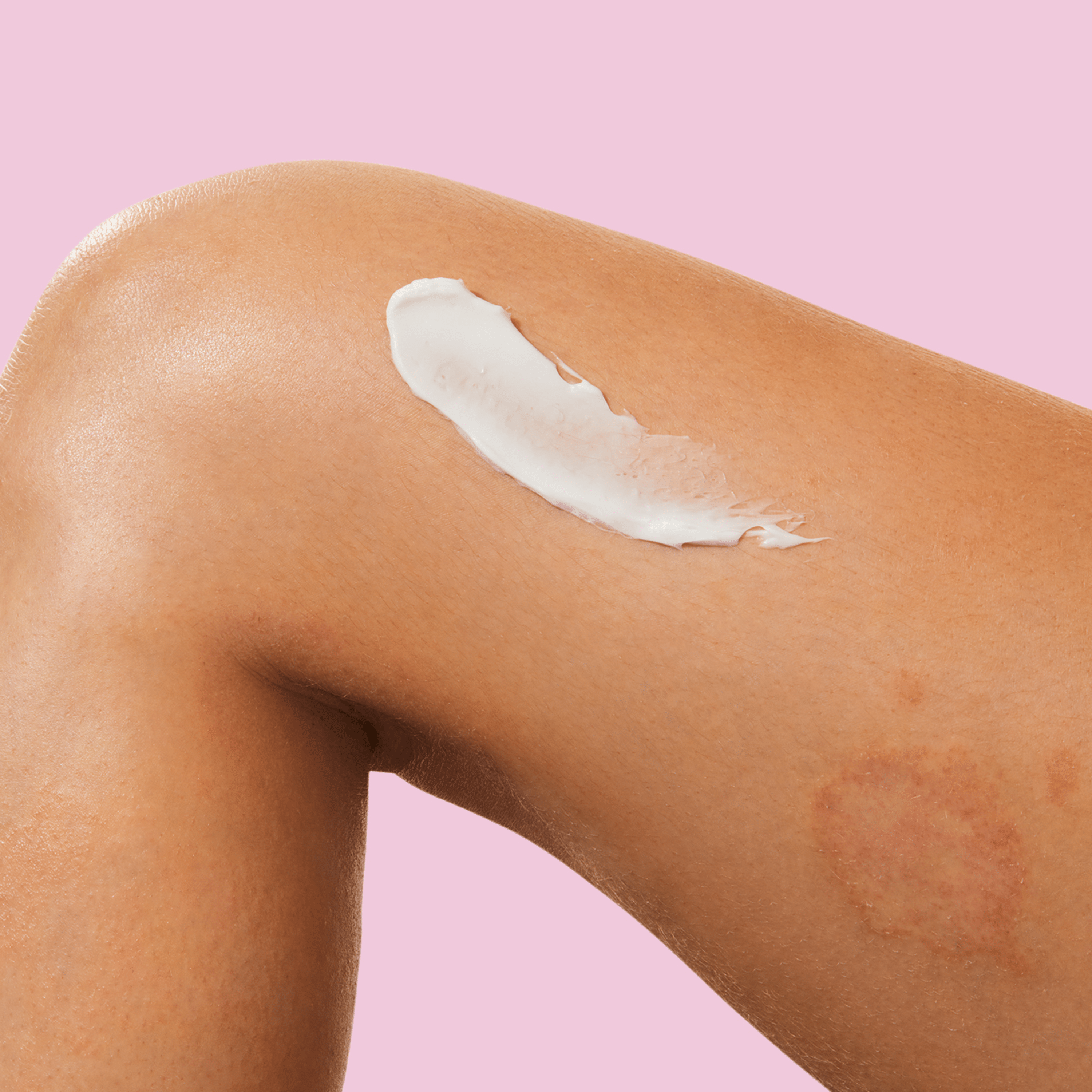 A swab of white cream on the thighs of a woman.