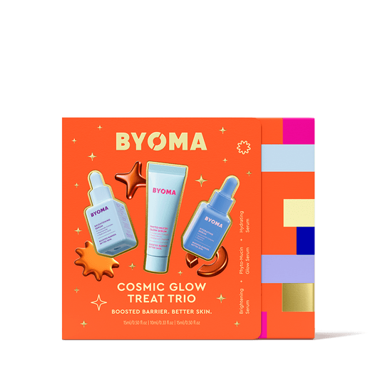 Orange BYOMA box design for the Cosmic Glow Treat Trio, showing illustrations of three products: Brightening Serum, Hydrating Serum, and Phyto-Mucin Glow Serum. Surrounded by shiny abstract orange blobs and colorful sidebar strips.