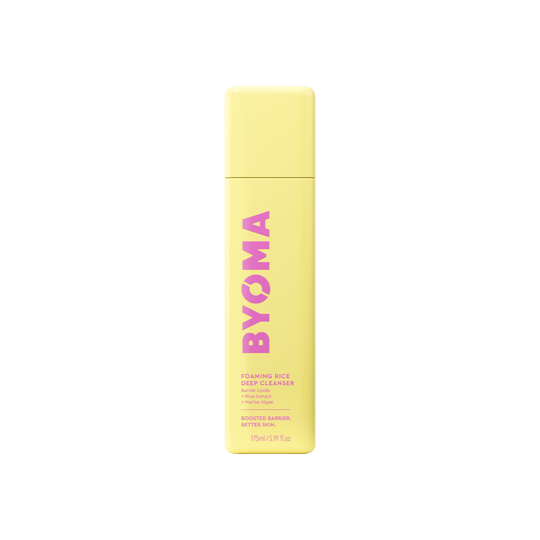 Yellow bottle of BYOMA cleanser on a green background