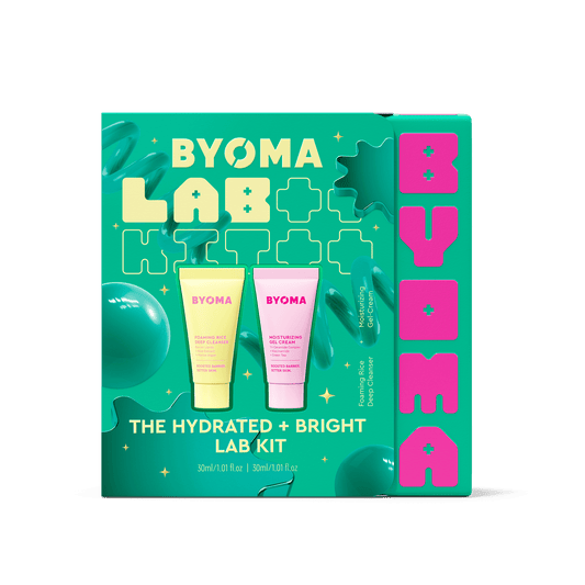 Byoma Lab Kit 'The Hydrated + Bright Lab Kit' in its retail box, featuring a bright teal background with lime green and hot pink graphics, showcasing two tubes of skincare cream inside.