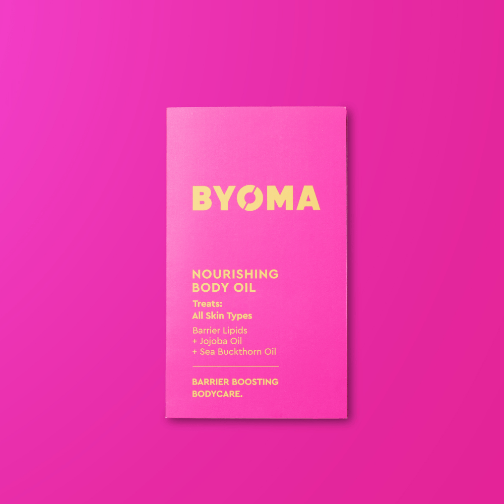 BYOMA nourishing body oil sample on a pink background